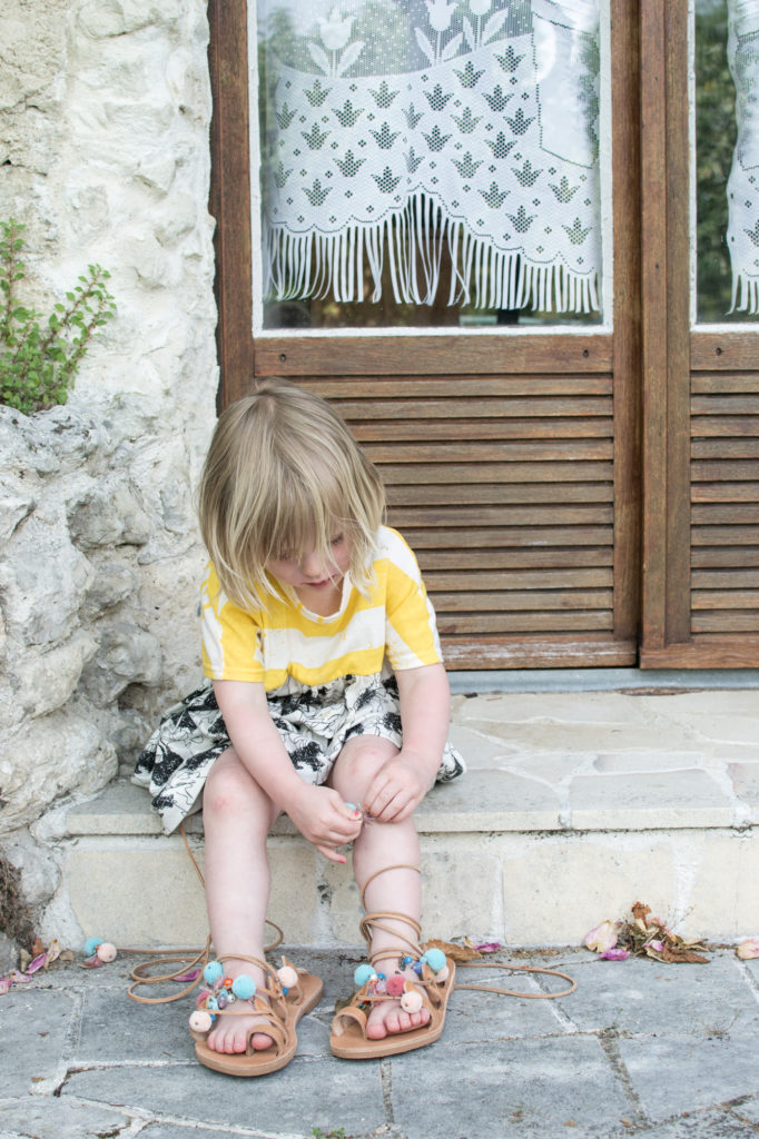 Daisy trying on pom pom sandals from IRIS