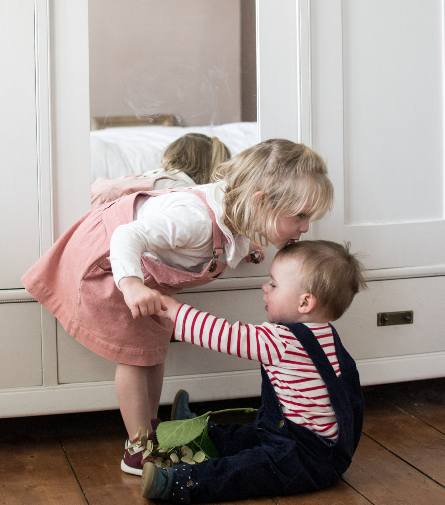 Pink Pinafore Dress from Dotty Dungarees & Bobux Trainers plus navy dungarees from Dotty Dungarees