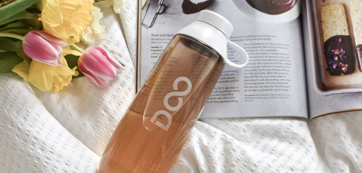 Drinkfinity reusable bottle filled with Chill with flowers and a magazine