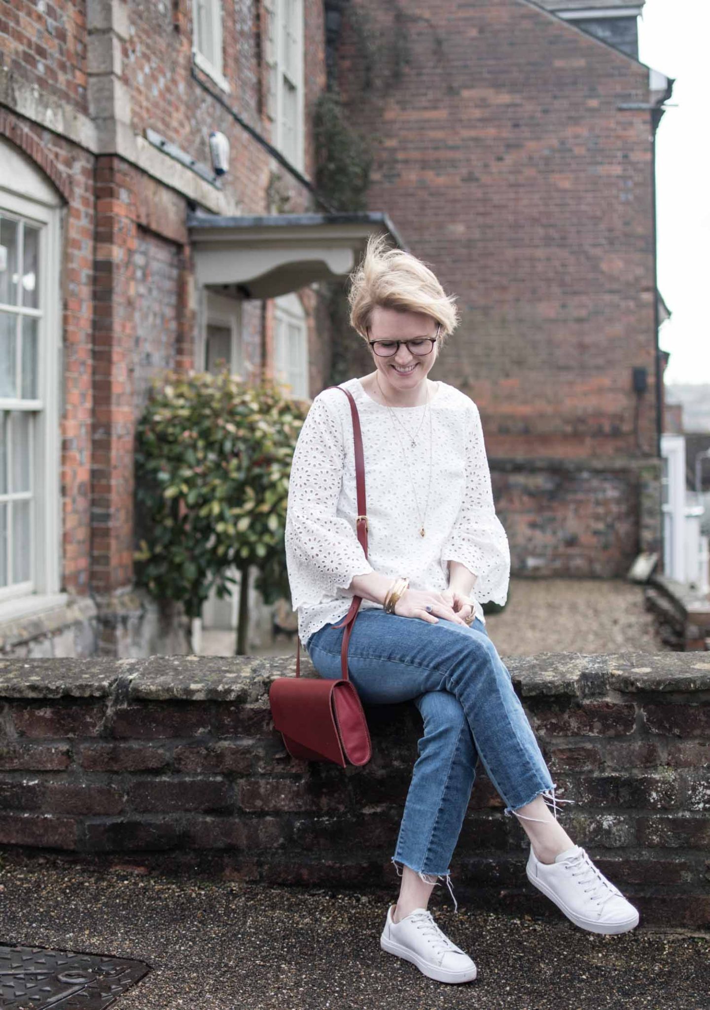 Sustainable Style Blogger Karen Maurice of n4mummy wearing Thoughts White embroidered top styled with jeans and a red bag. 