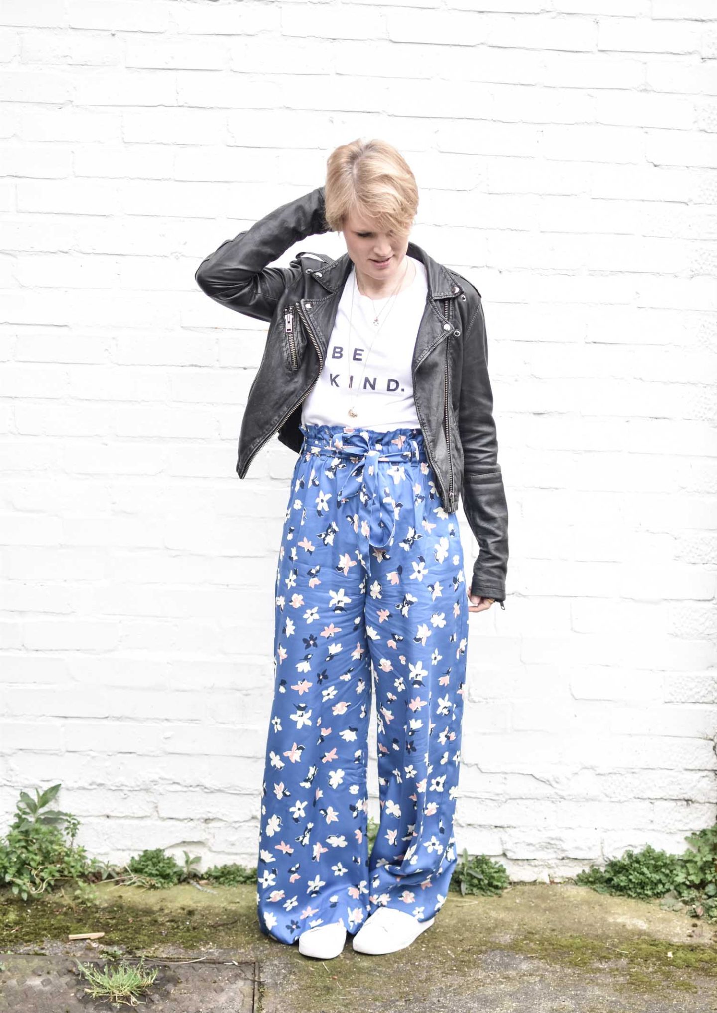 Ethical Fashion Blogger Karen Maurice of n4mummy wears wide floral trousers by People Tree, a slogan T from Self Care Co and a leather jacket