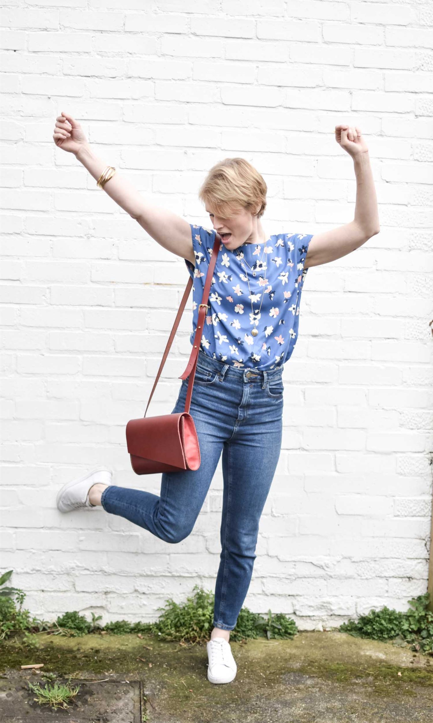 Ethical Fashion Blogger Karen Maurice of n4mummy wearing a floral top from People Tree, Mom jeans from Asos Eco Edit and a TOMS trainers