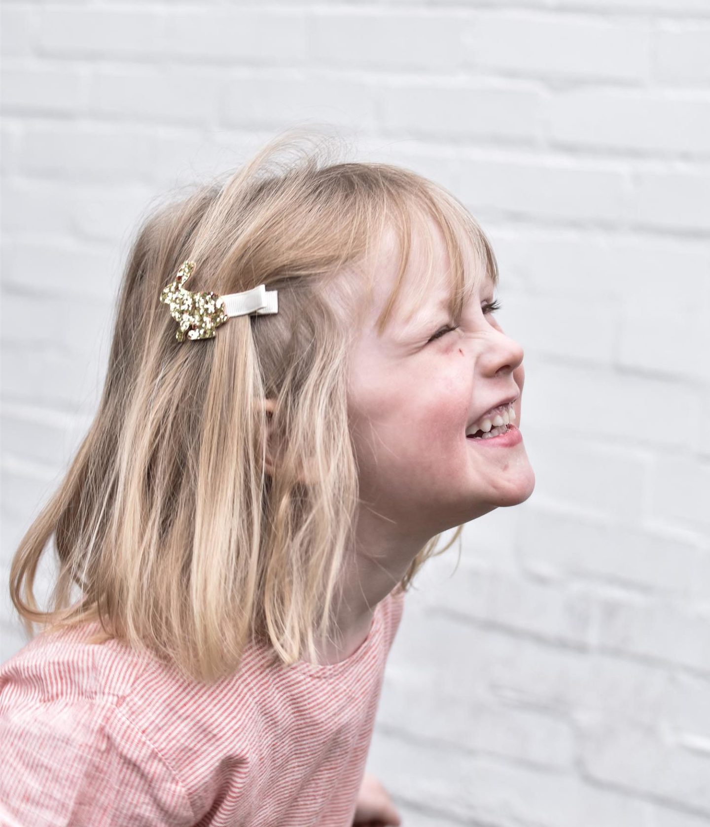 Daisy wears a smock dress from Tootsa MacGinty and a sparkly rabbit clip from Glammrags