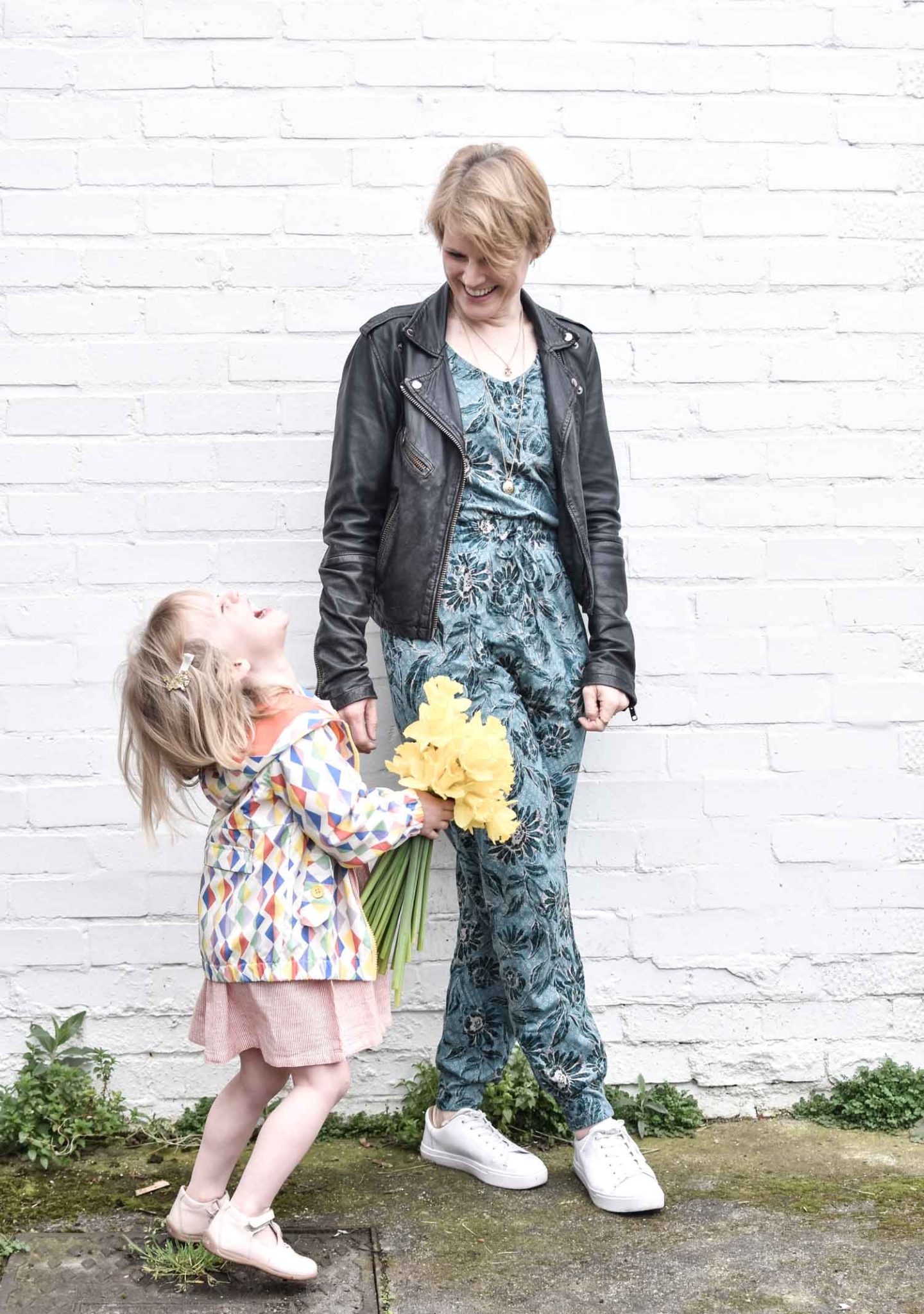 Ethical Fashion Blogger Karen Maurice of n4mummy wearing a floral jumpsuit from Thought with a leather jacket with her daughter