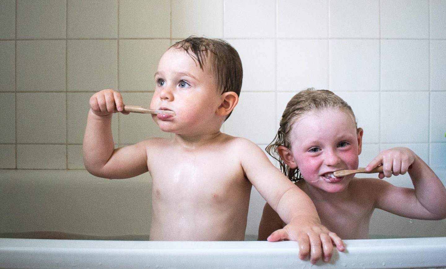 Children of n4mummy using their bamboo toothbrushes to brush their teeth. 