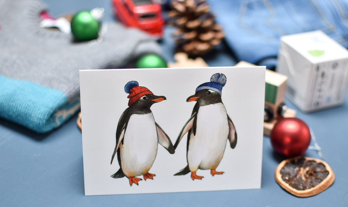 Card with penguins with hats on from Etsy UK