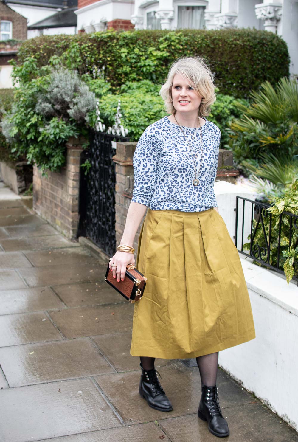 Karen Maurice of n4mummy wears leopard print top and yellow skirt both from Oxfam, carrying a Katherena bag