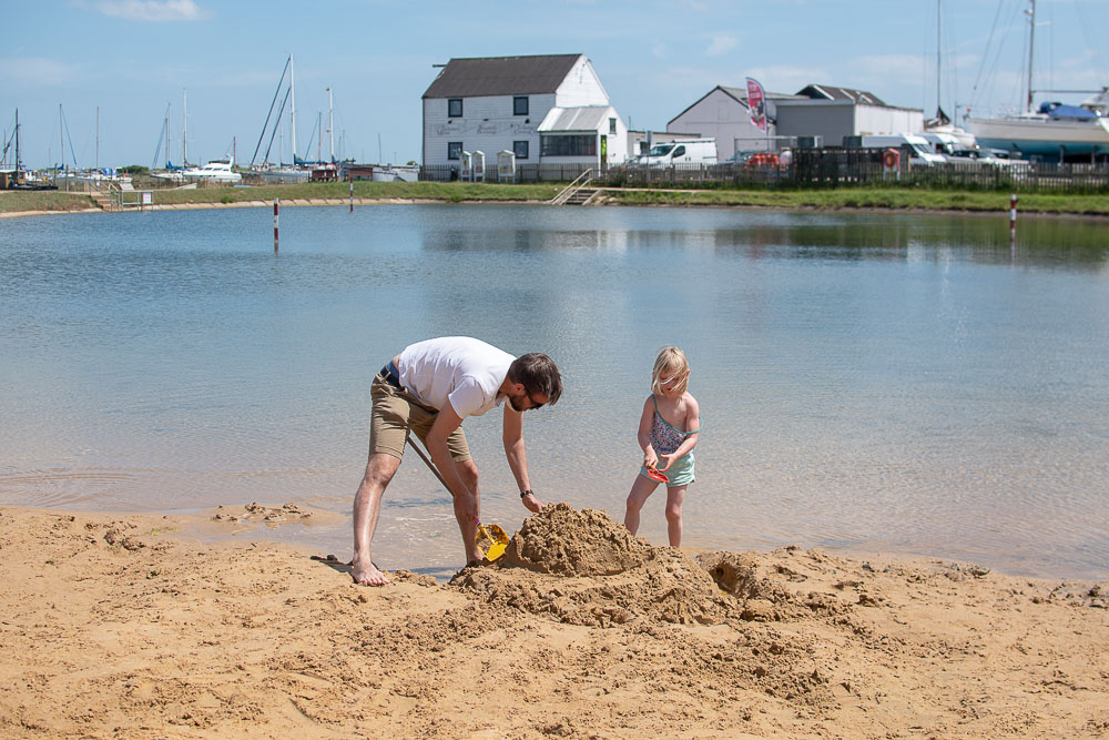 James and Daisy building a sandcastle at the outdoor pool at Tollesbury