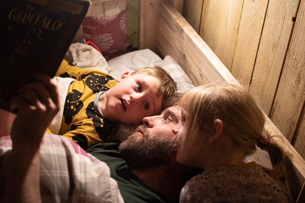 Glamping at Birdsong, reading stories to the children inside our safari tent