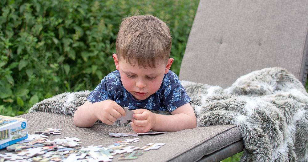 Laurie doing a puzzle, glamping at Birdsong Chigborough Farm and Fisheries