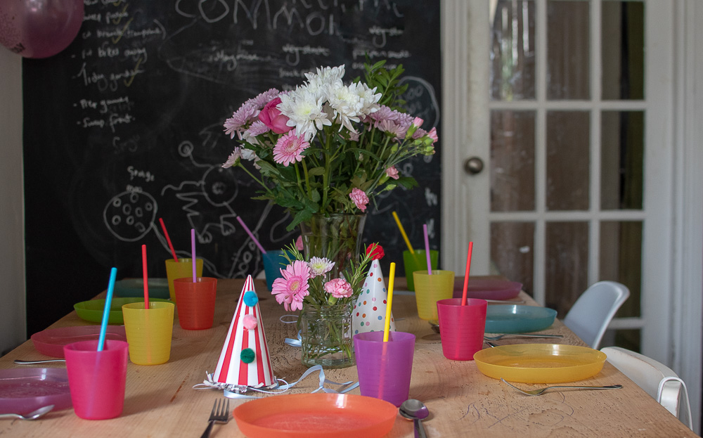 zero waste party decorations, fresh flowers, and party hats that we will use again