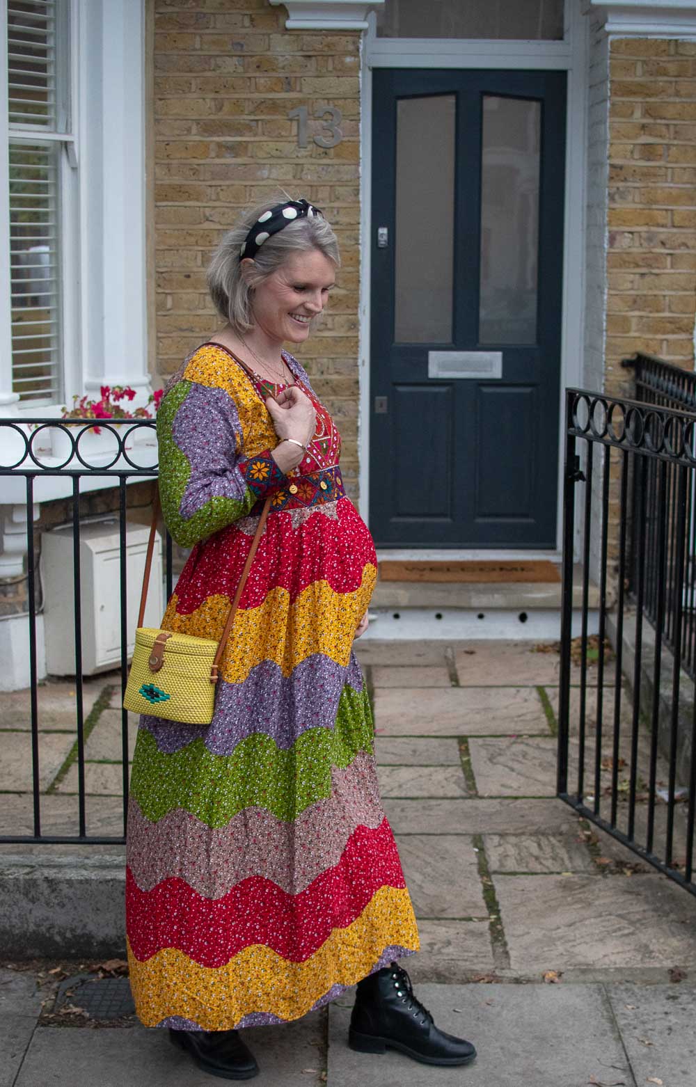 Karen Maurice of n4mummy wearing a colourful rainbow dress, spotty hairband and yellow bag