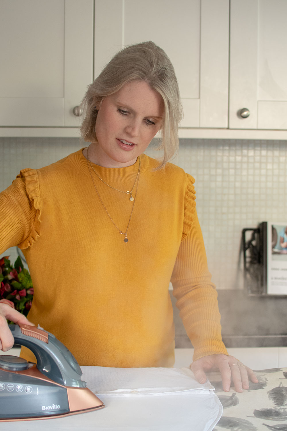 Ironing a shirt, which can help extend the life of your clothes as they look so much better