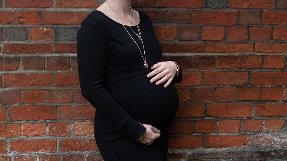 Karen Maurice of n4mummy wears a skinny ribbed black dress from Boob at 36 weeks pregnant