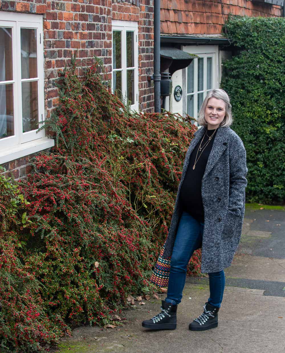 Karen Maurice of n4mummy wearing a black skinny maternity jumper, maternity herringbone coat and skinny maternity jeans from Jo Jo Maman Bebe, Ethical Maternity Clothes
