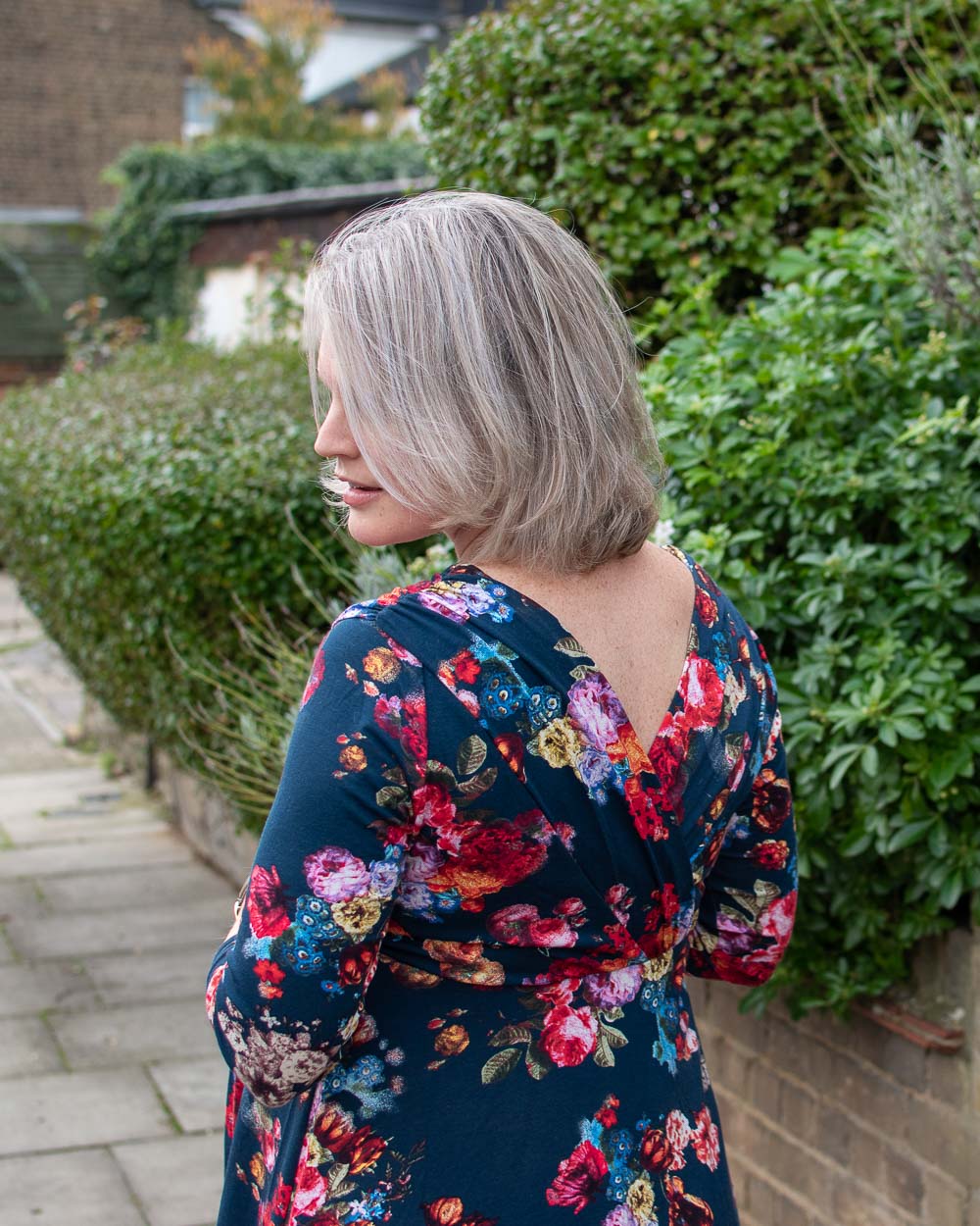 The deep v back of the floral dress from ethical maternity brand Tiffany Rose