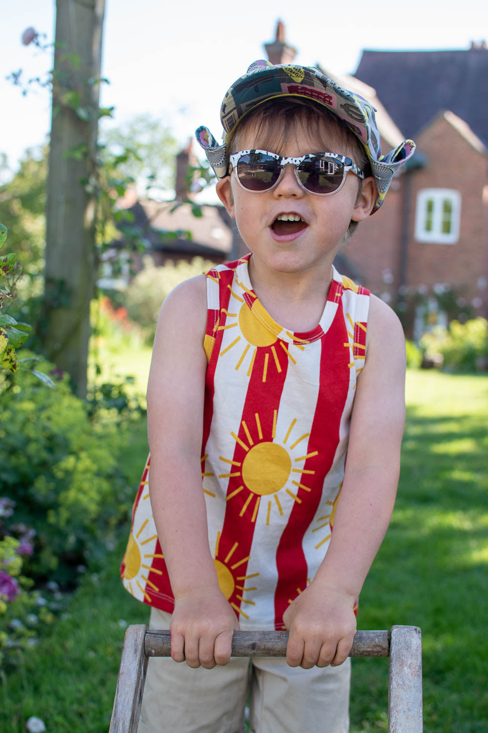 Laurie wearing a second hand Mini Rodini sunshine striped T shirt from Slof