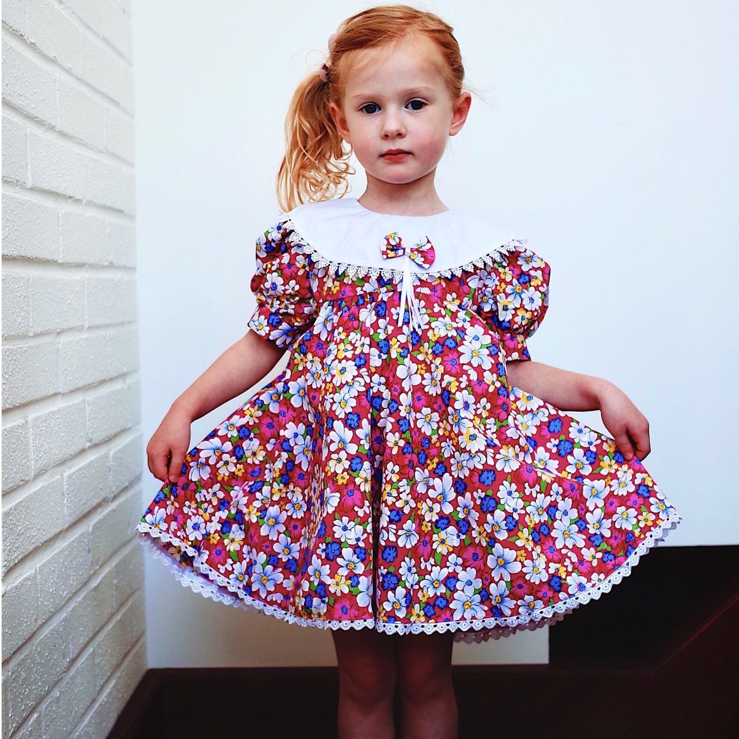 girl in a floral vintage dress from second hand clothing brand Wolf & Mabel