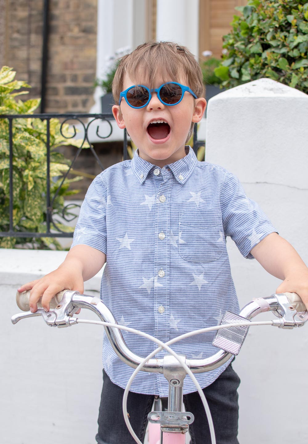 Young boy in a star blue shirt from second hand cildren's clothing brand Tot Swap