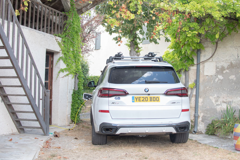 White BMW X5 Plug-in Hybrid, charging whilst on holiday in France. BMW X5 Review