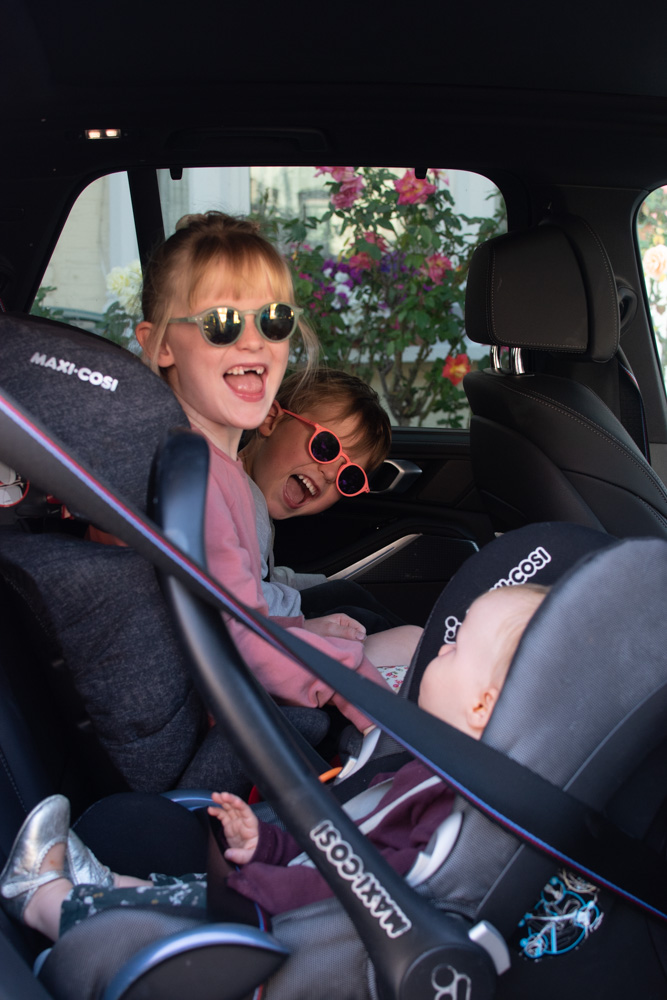 Three children sitting in the BMW X5 Plug-in Hybrid car, showing you can fit three children into a BMW X5 Plug-in Hybrid.