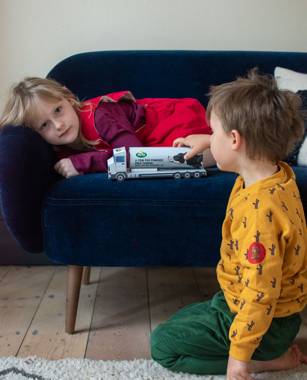 My kids playing with Arla's toy milk tanker that will be powered by cow poo, to help them to reduce their  carbon footprint.  