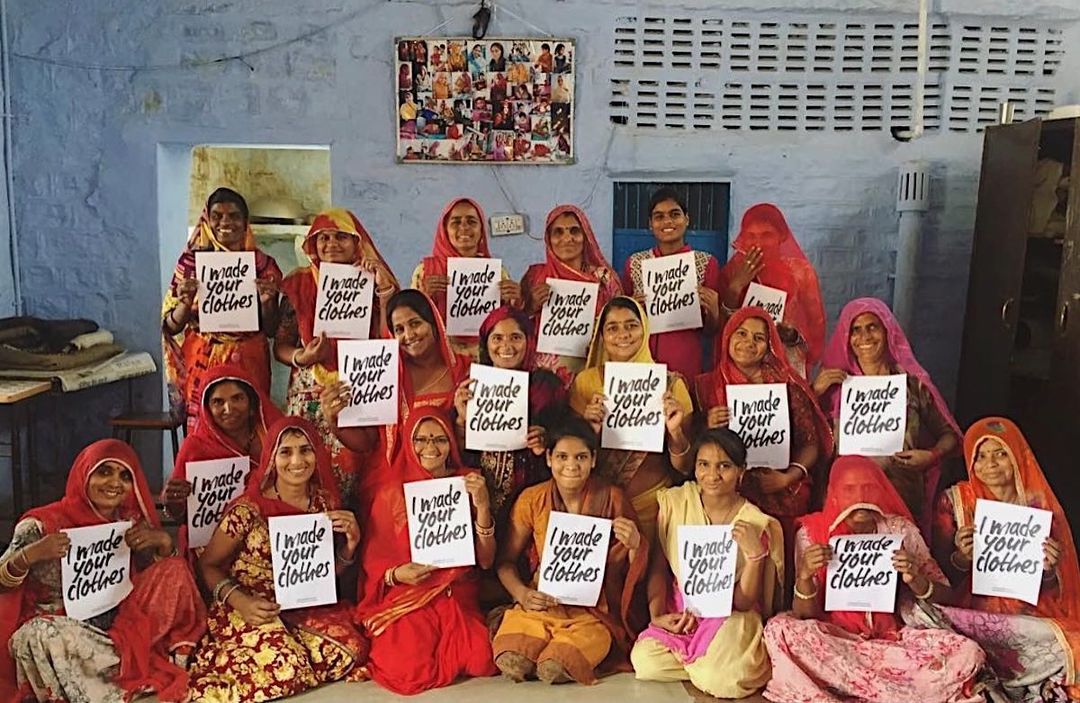 Picture of @_saheliwomen holding 'I made your clothes' posters, ethical shopping 