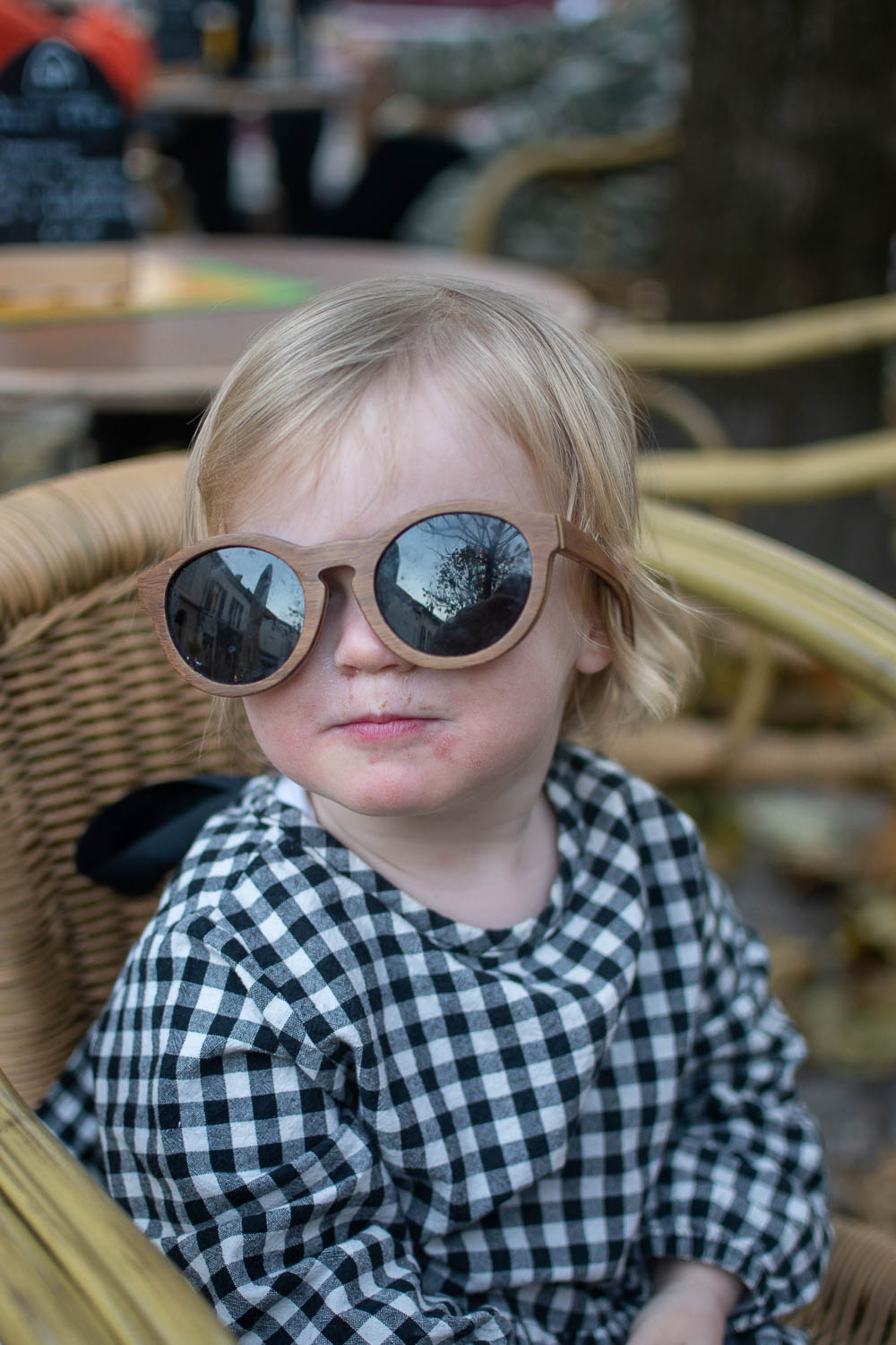 A child wearing a gingham top bought from preloved shop Manifesto Woman